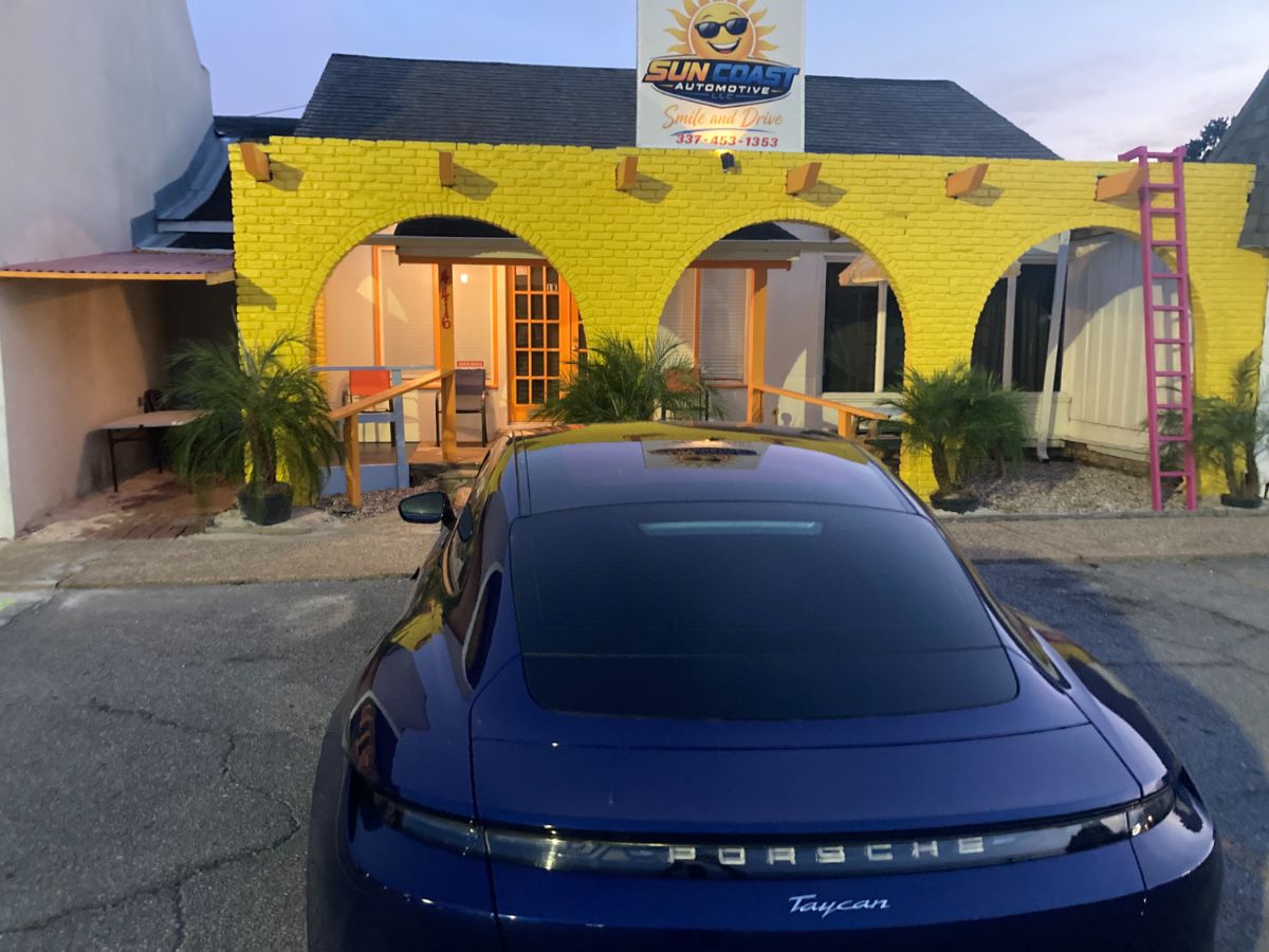 Shop front at dusk with a vehicle out front